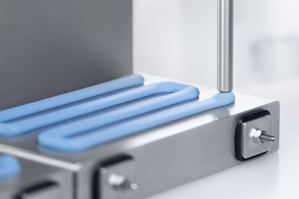 A silicone gap filler from Wevo being applied to a battery.